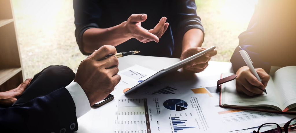 business people using pen,tablet,notebook are planning a marketing plan to improve the quality of their sales in the future.